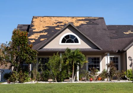 House with roof damaged by storm.
