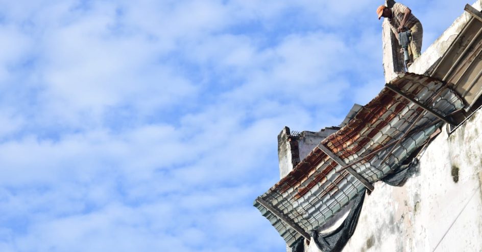 Roof coating contractor working on a New Orleans home roof